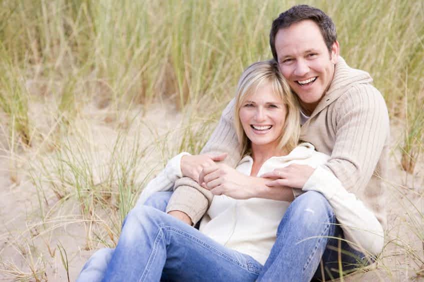 3600307 - couple sitting on beach smiling